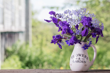 beautiful bouquet with irises on wooden table