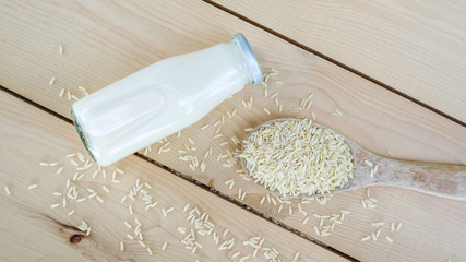 Germinated brown rice drink and brown rice on a wooden table.