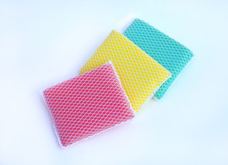 multi-colorful kitchen sponges for ware washing on white background.