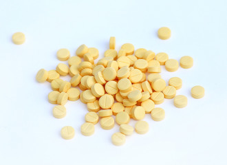 Pile of Small medicine tablets on white background.