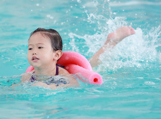 Fototapeta na wymiar Little asian baby learning to swim.