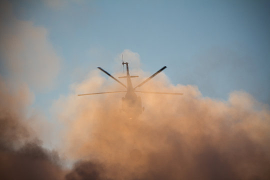Fire extinguishing background, fire helicopter in smoke