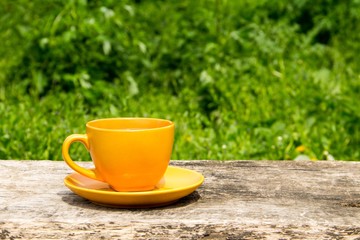 Coffee cup on rustic wooden table outdoor