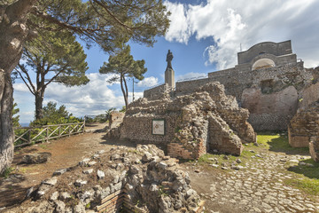 The statue of Virgin Mary with Jesus and church on the ruins of Tiberius Villa Jovis on island Capri, Italy © tynrud