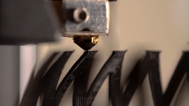 A 3D printer working to create a modern abstract bowl.