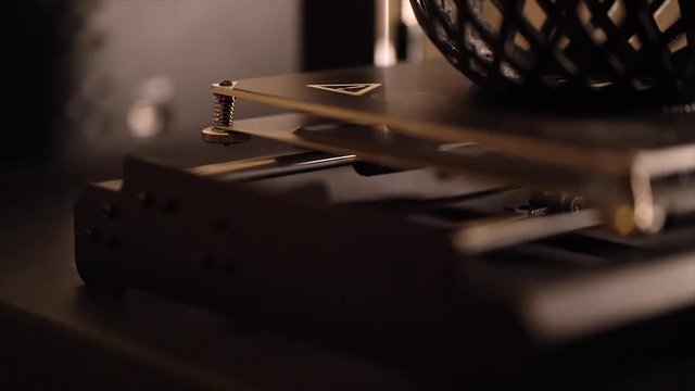 A 3D printer working to create a modern abstract bowl.