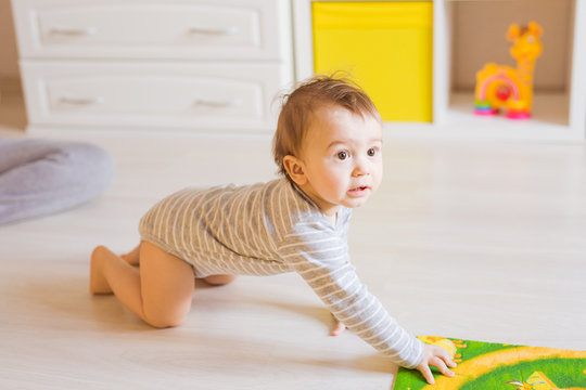 Portrait of crawling funny baby boy indoors at home