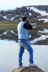 Landscape photographer photographing mountain lake