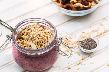 Smoothie topped with granola in a mason jar