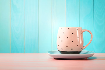 Coffee mug on bright pink and blue background