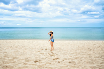 Fototapeta na wymiar Happy young woman on the beach