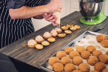 Chef cook baking sweets on a modern kitchen