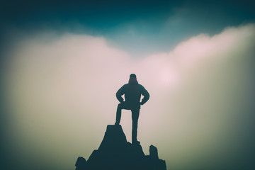 Hiker standing on the edge. Instagram stylization