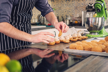 Chef cook baking sweets on a modern kitchen