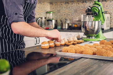 Chef cook baking sweets on a modern kitchen