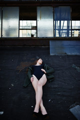 Sexy model girl wit long legs at black lingerie outfit body swimsuit combidress and jacket posed at...