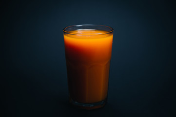 Fresh orange juice on black background.