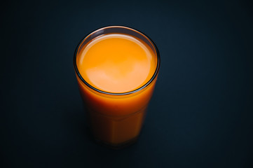 Fresh orange juice on black background.