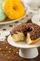 Colorful donuts on a wooden background.