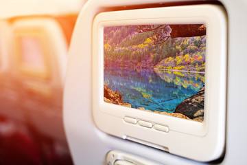 Aircraft monitor in front of passenger seat showing lake in Jiuzhaigou National Park