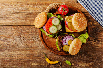 Homemade, beef hamburger with cheese and vegetables.
