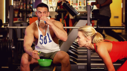 Sports nutrition man eats in a gym