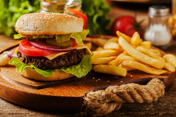 Homemade, beef hamburger with cheese and vegetables.