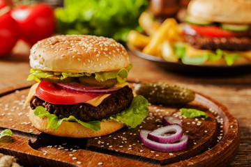 Homemade, beef hamburger with cheese and vegetables.