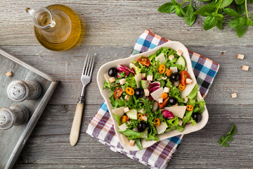 Italian salad with fresh vegetables with black olives and Parmesan cheese.