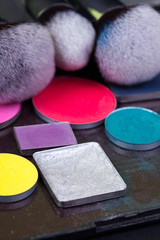 Eye shadow palette in natural colours and makeup brushes