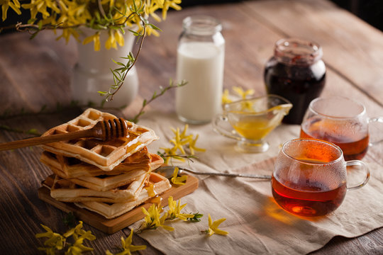 Waffles, Tea, Honey And Milk On A Neutral Background