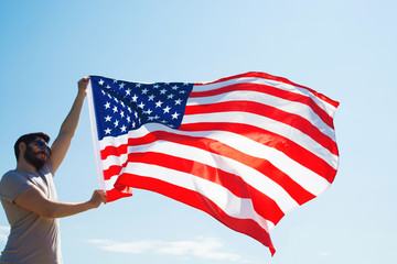 man is holding waving american USA flag. 