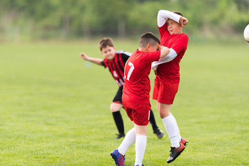 Obraz premium Kids soccer football - children players match on soccer field