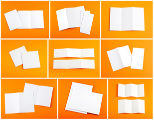 blank white folding paper flyer on orange background