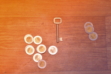 old key with coins, financial concept
