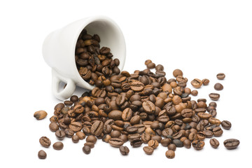 overturned coffee cup with bunch of coffee beans, on white background