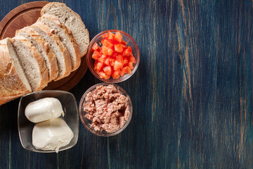 Ingredients ready for preparing bruschetta with tuna, mozzarella