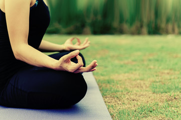 Asia Beautiful girl practicing yoga in quiet nature