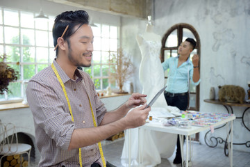 designer concept : Fashion designer working near mannequin in office