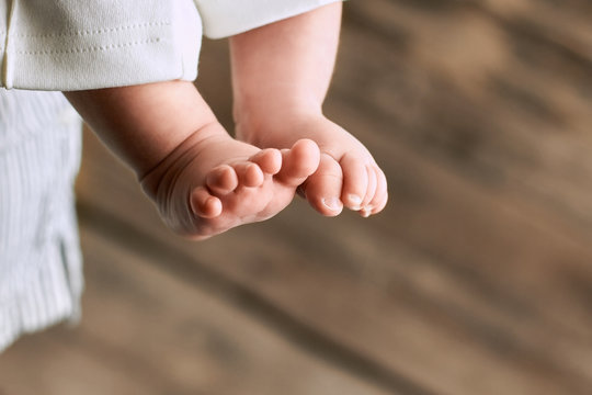 Feet of baby close up. Childish legs on blurred background. Things to know about newborns.