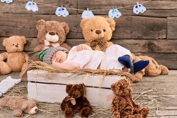 Teddybears and sleeping kid. Child lying on hay. How long should children sleep.