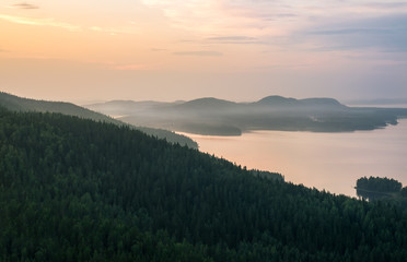 Scenic landscape with lake and sunset at summer evening in national park Finland