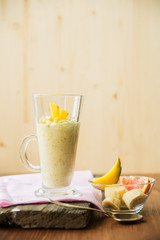 Banana smoothie on a rustic wooden table
