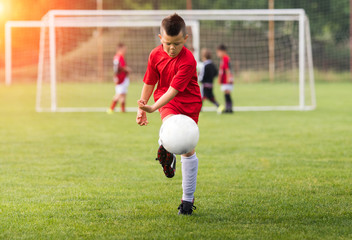 Kids soccer football - children players match on soccer field