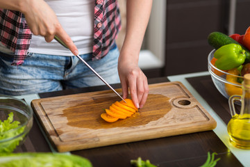 Woman preparing salad in the kitchen