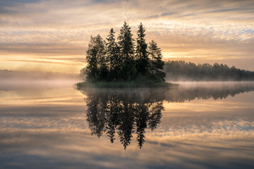 Scenic landscape with sunrise and idyllic island at early morning in Finland