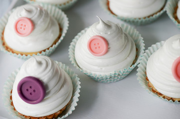Basket of cream in a paper wrapper.Culinary syringe. beautiful cream hat decorated with buttons