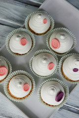 Basket of cream in a paper wrapper.Culinary syringe. beautiful cream hat decorated with buttons