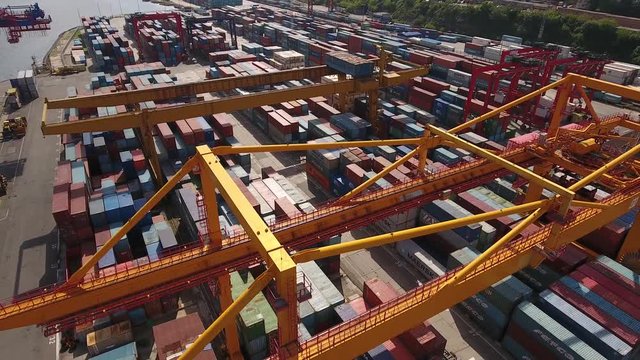 Free port zone Vladivostok Russia Primorsky krai. Local industrial containers cranes transport heavy equipment. Embankment Golden horn. Port unloading Freight. Summer day Unique Aerial flight close to