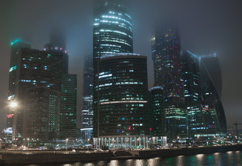 Moscow City. View of skyscrapers in fog, night lights. 